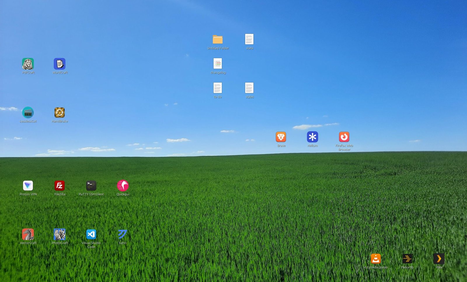 A Cinnamon desktop with app icons and documents scattered across a sky and grass wallpaper